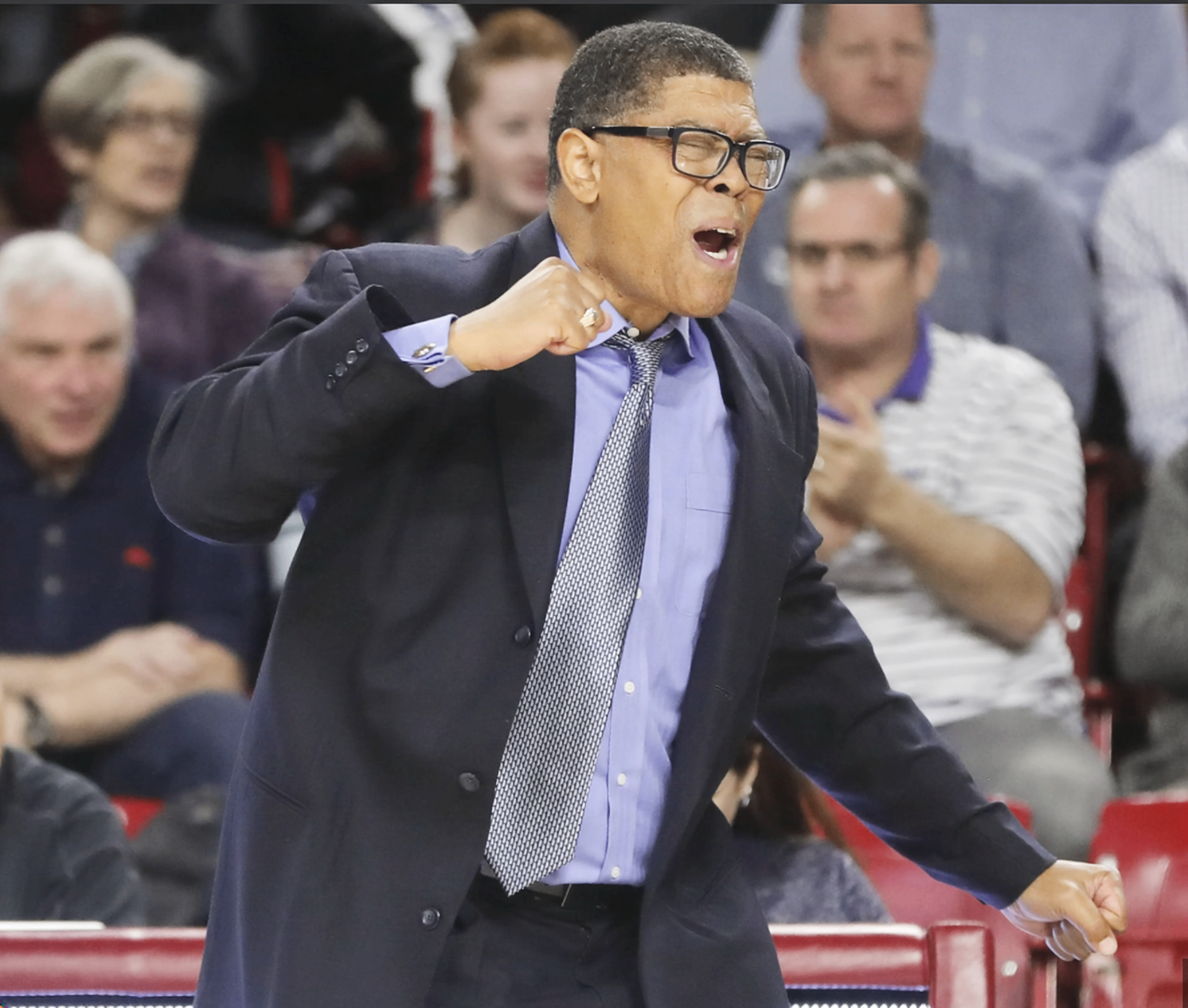Coach Gino Crump reacting with intensity on the sideline during a game